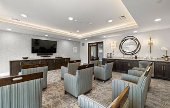 A lounge area with chairs and a television